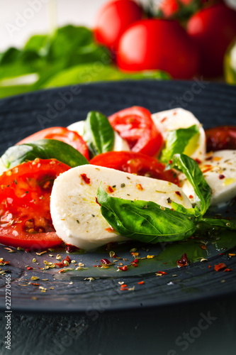 Caprese salad with mozzarella, fresh tomato and basil