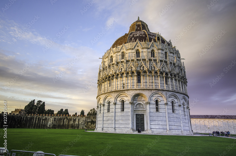Medieval round Romanesque Pisa Baptistery of St. John (Battistero di Pisa) at Piazza dei Miracoli (Square of Miracles) or Piazza del Duomo (Cathedral Square) in Pisa, Tuscany, Italy at sunset