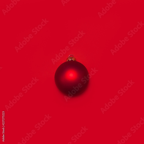 Red Christmas ball on red background Flat lay top view copy space. Christmas winter decoration Xmas holiday. Congratulations background, New Year concept