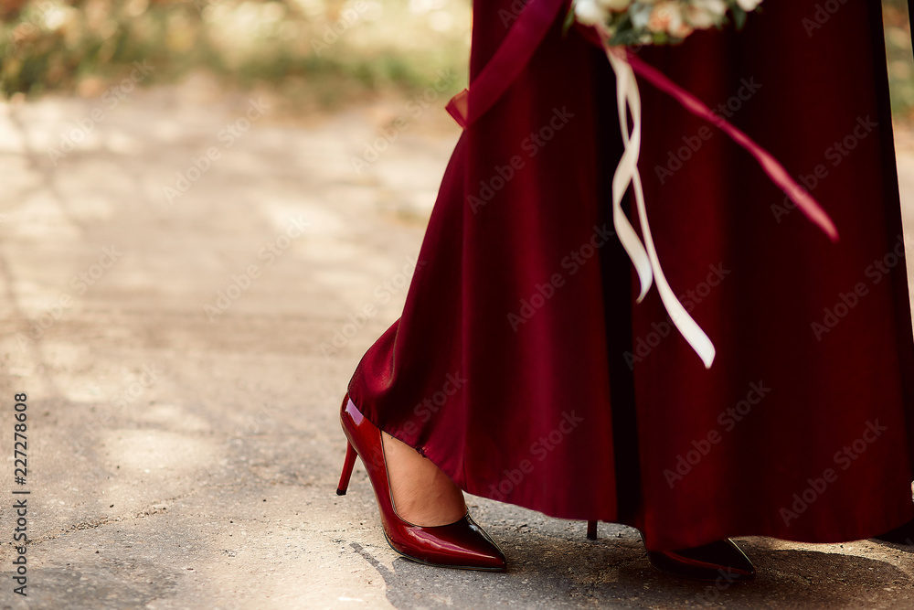 red stiletto shoes and bridesmaid dress with a bouquet of different colors