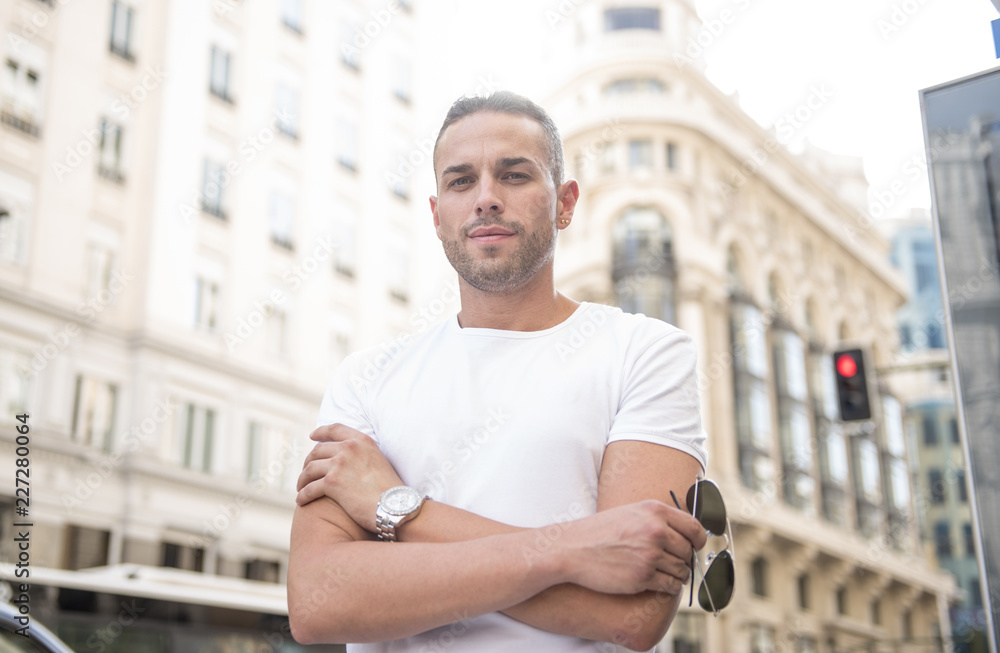 Handsome man posing in the center of the city Handsome man posing in the center of the city