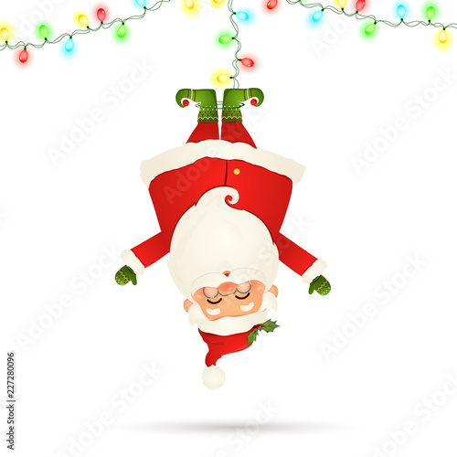 Smiling Santa Claus cartoon character hanging upside down with garland string of twinkle lights with multicolored bulbs isolated on white background. Santa clause for winter and new year holidays.