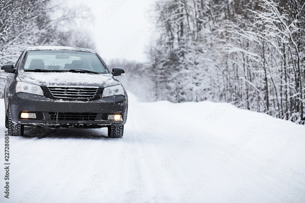 The car stands on a snow-covered road The car stands on a snow-covered road