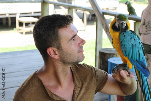 Exotic bird bonding with a man 