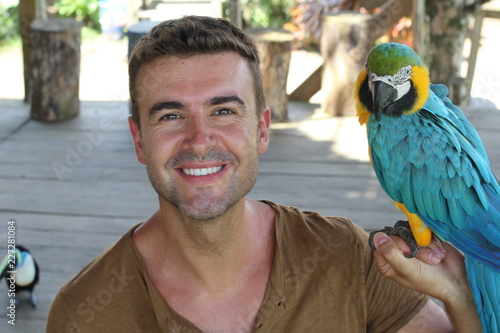 Bird tamer working with a macaw 