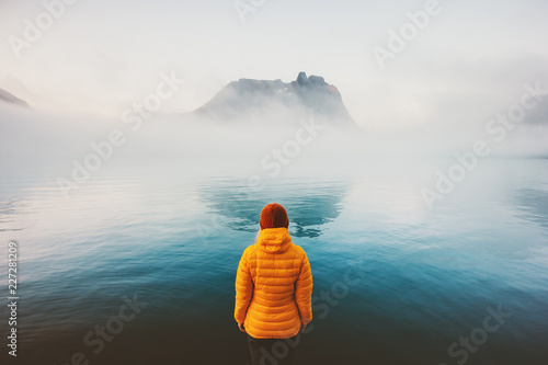 Woman looking at foggy sea