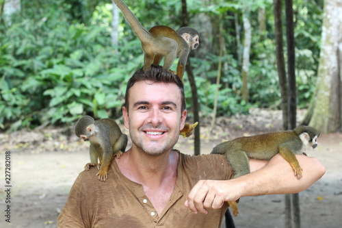 Handsome man with titi monkey's group