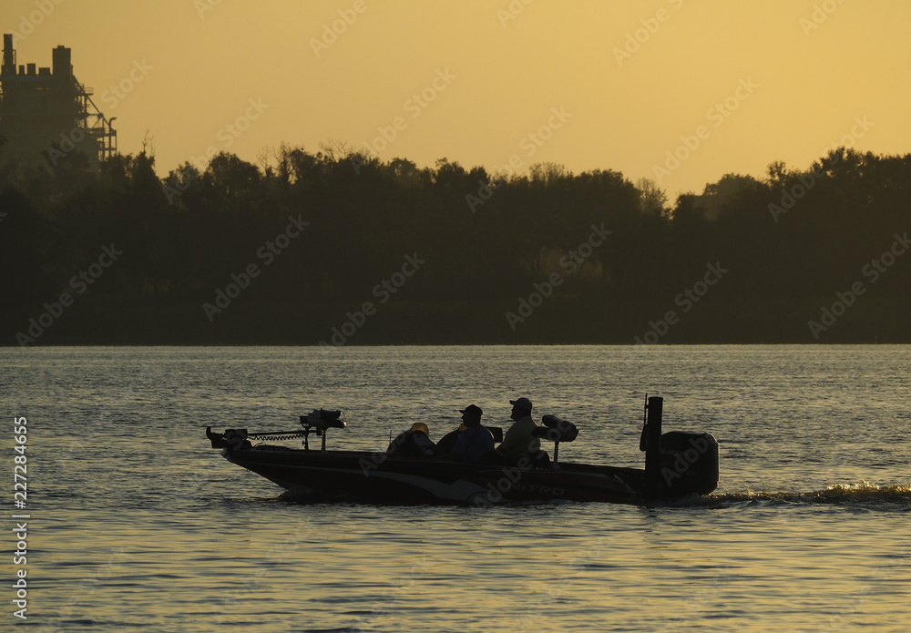 Two Fishermen Race to Their Favorite Fishing Spot in Their Bass Boat at Sun Rise