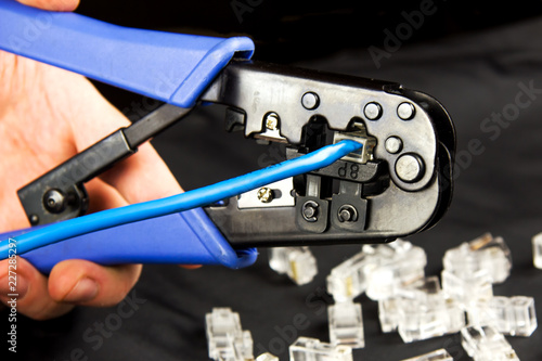 Hand crimps a patch cord with connector