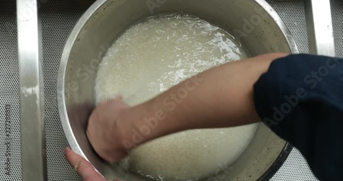 Person hand preparing, washing, stirring, traditional asian rice2 photo