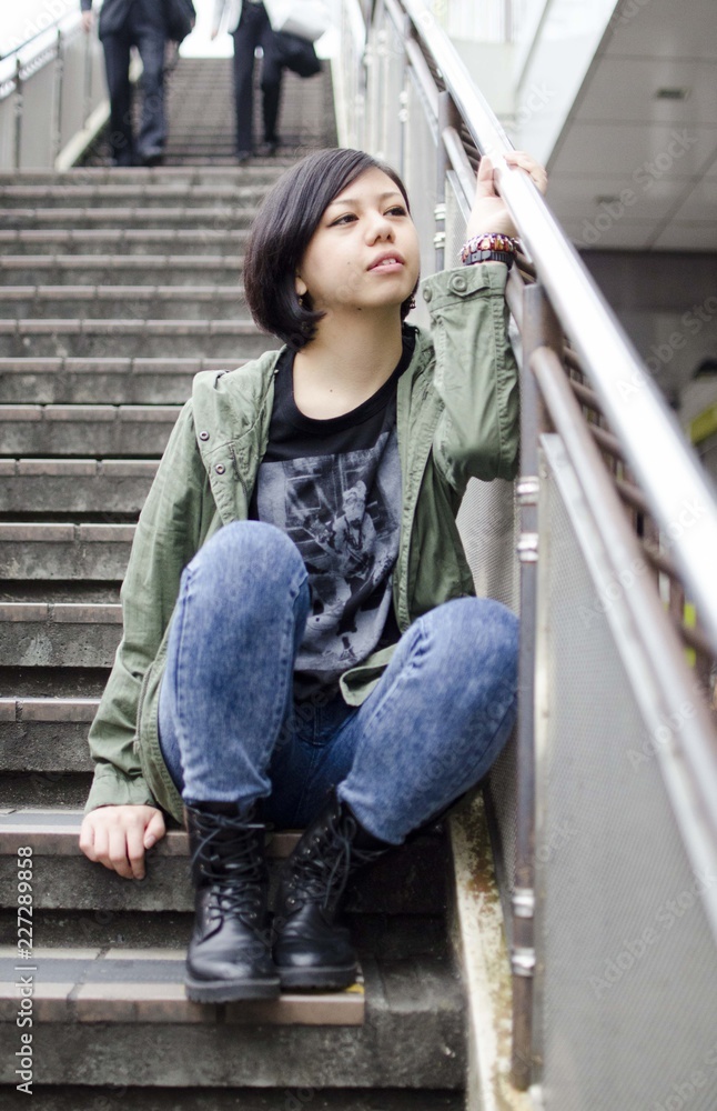 Japanese Girl poses on the street in Machida, Japan. Machida is an area located in Tokyo.