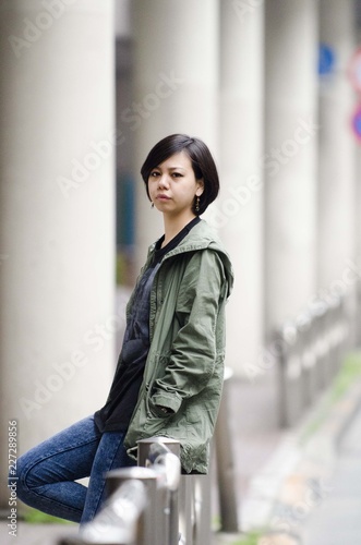 Japanese Girl poses on the street in Machida, Japan. Machida is an area located in Tokyo. photo