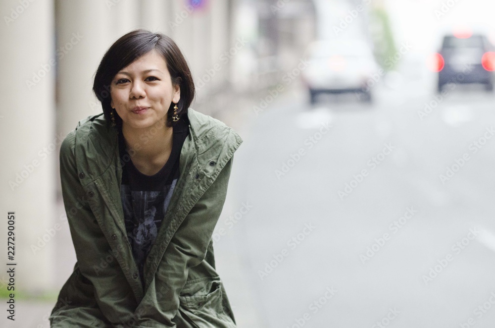 Japanese Girl poses on the street in Machida, Japan. Machida is an area located in Tokyo.