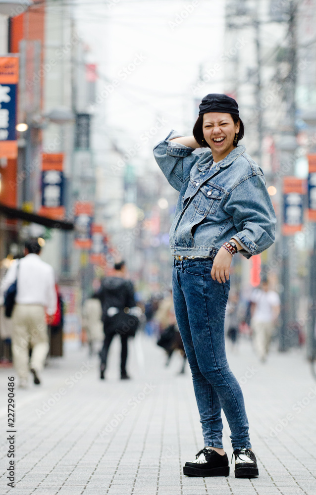 Obraz premium Japanese Girl poses on the street in Machida, Japan. Machida is an area located in Tokyo.