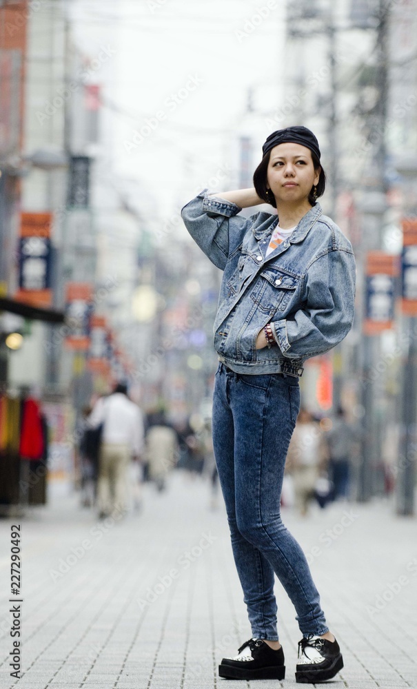 Japanese Girl poses on the street in Machida, Japan. Machida is an area ...