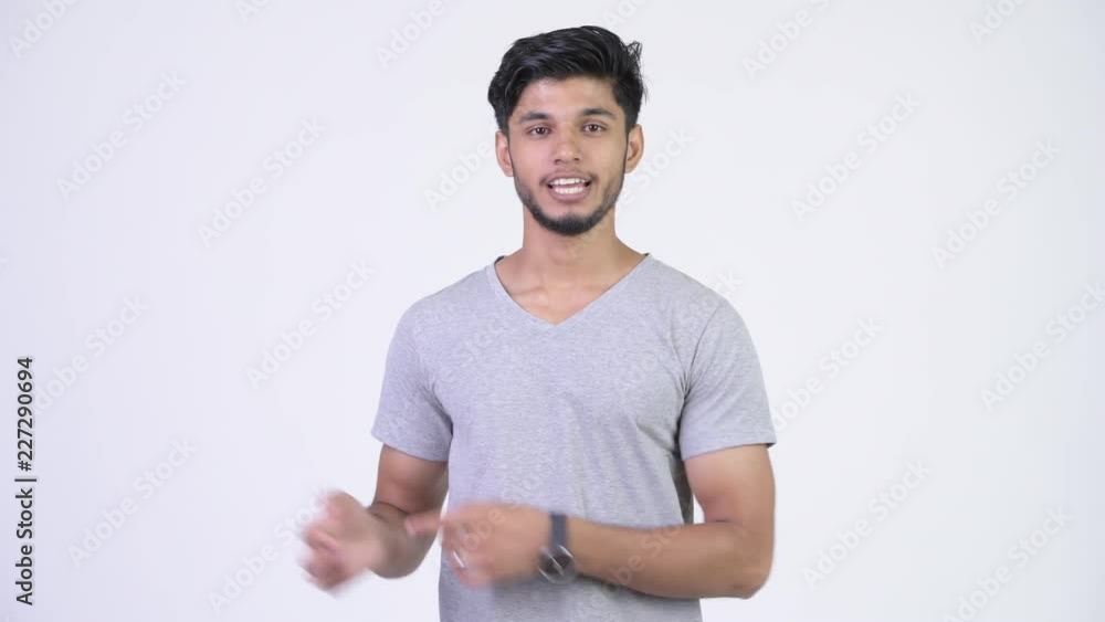 Young handsome bearded Indian man explaining something Young handsome bearded Indian man explaining something