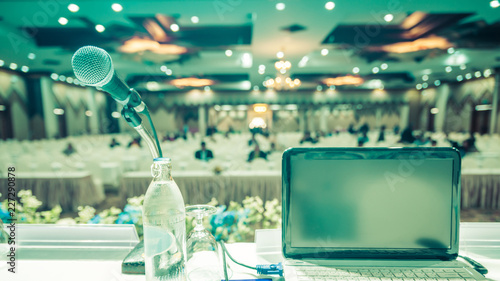 Laptop and microphone defocus in meeting room  Seminar blur background in hall.