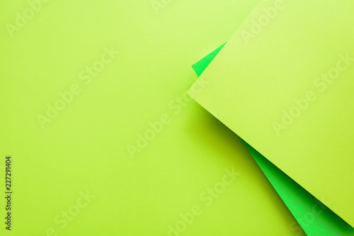 Green and lime pastel color papered background. Volume geometric flat lay. Top view. Copy space