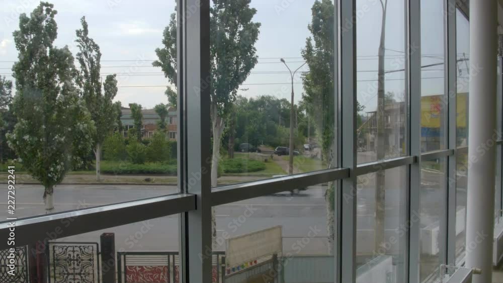 4K timeslapse view from huge window on the road and the poplar swinging in the wind 4K timeslapse view from huge window on the road and the poplar swinging in the wind