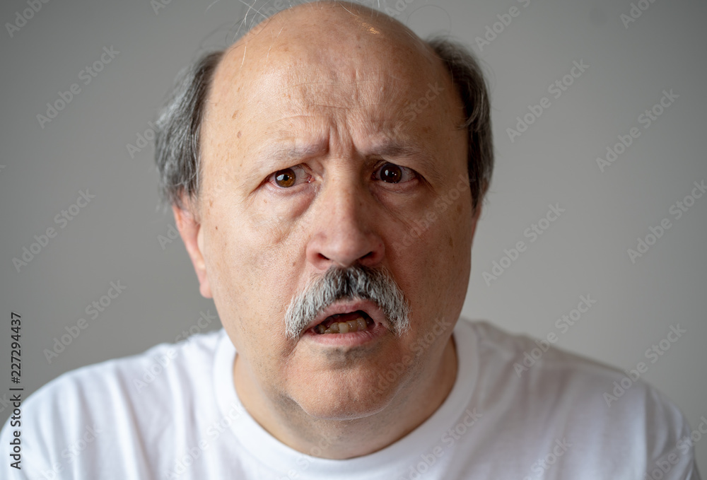 Portrait of disorientated and confused old man suffering from Alzheimer Portrait of disorientated and confused old man suffering from Alzheimer