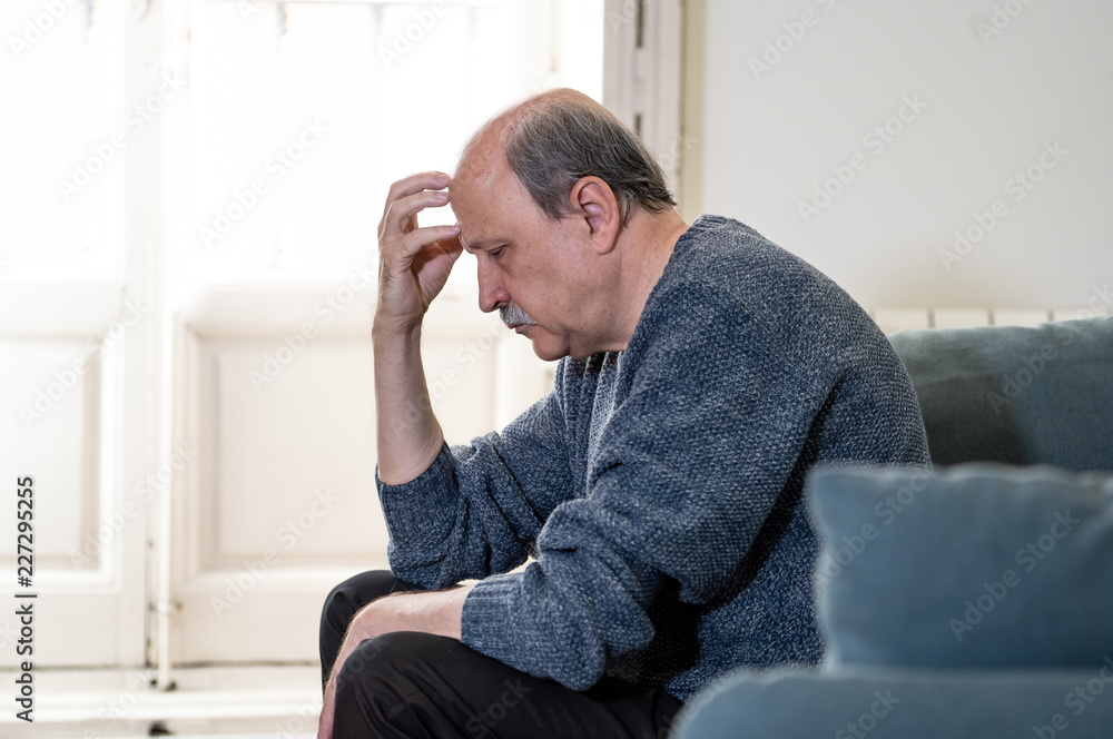 Depressed overwhelmed old man feeling exhausted alone and unhappy suffering from depression
