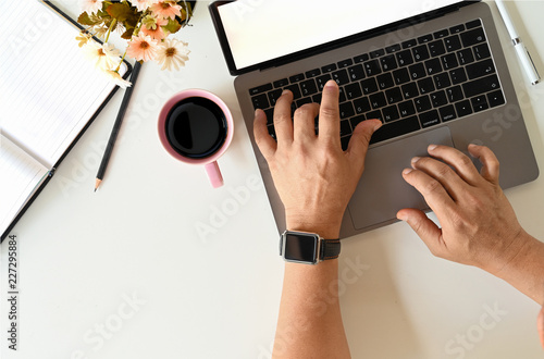 Fototapeta Naklejka Na Ścianę i Meble -  Top view male hand using laptop and office accessories