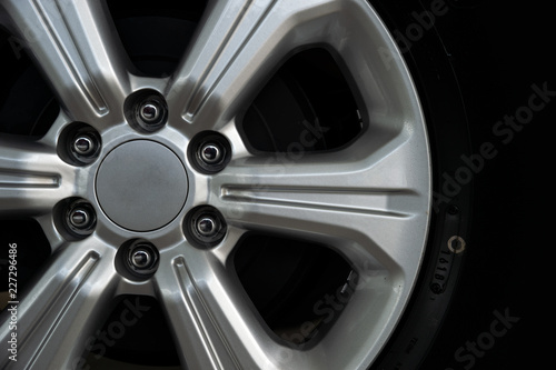 closeup alloy car wheels with soft-focus and over light in the background © memorystockphoto