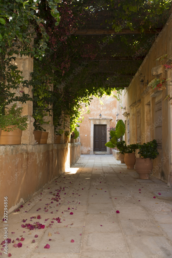 Alley in monastery of Agia Triada, Crete, Greece. Monks cell entrance door