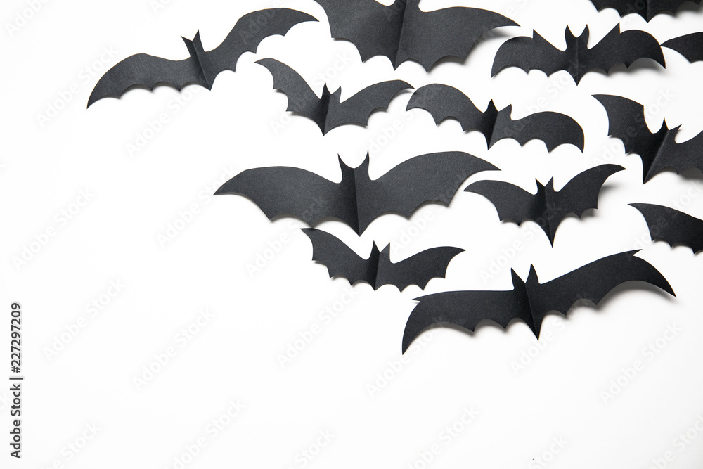 Fototapeta premium Halloween paper bat decorations on a white background.
