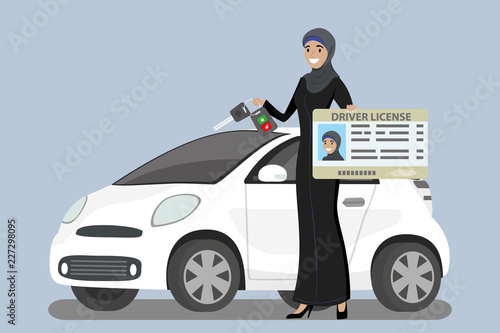 Happy Arab Girl or Saudi woman with driver license and car key in hands