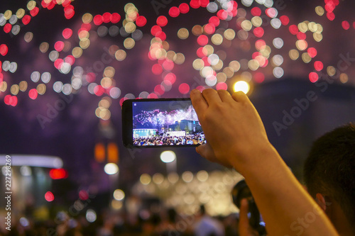 Holiday, colorful sky, fireworks shoots on smartphone