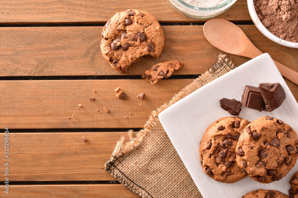Fototapeta premium Composition homemade biscuits with choco chips on slatted table top