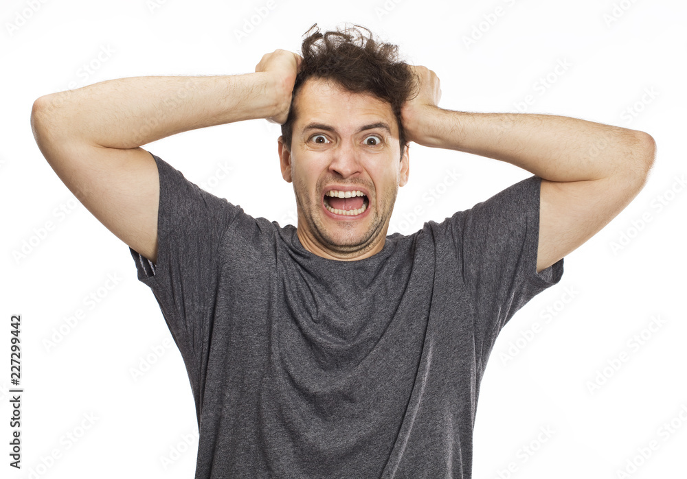 Portrait of an angry and furious male on a white background Portrait of an angry and furious male on a white background