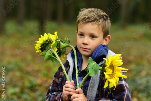 Small boy hold flowers for womans day. Small boy celebrate womans day. Celebrating international womans day. Equal rights for women every day