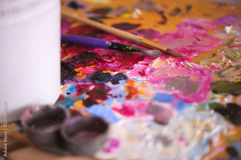 artists brushes and oil paints on wooden palette artists brushes and oil paints on wooden palette