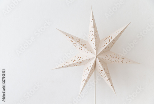 close up of vintage white  lantern with star shape on empty wall.