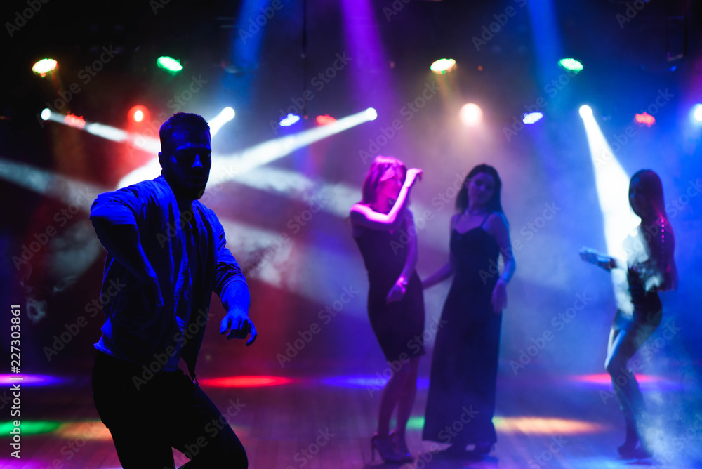 party, holidays, celebration, nightlife and people concept - group of happy friends dancing in night club party, holidays, celebration, nightlife and people concept - group of happy friends dancing in night club