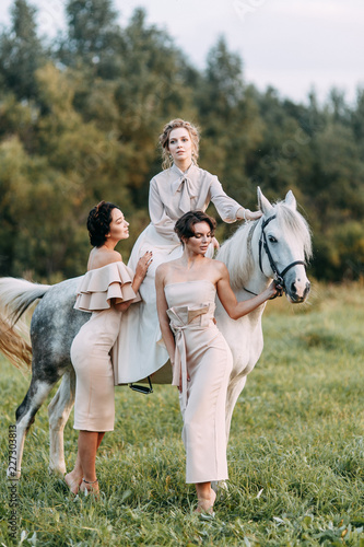 Wedding in American style, on a ranch with a horse. Walk couples in the fields at sunset, with friends and on horseback. Modern couple and ideas for the ceremony. © pavelvozmischev