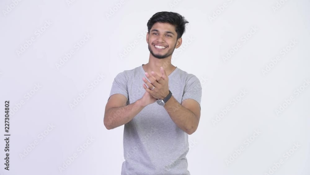 Young happy bearded Indian man clapping hands Young happy bearded Indian man clapping hands