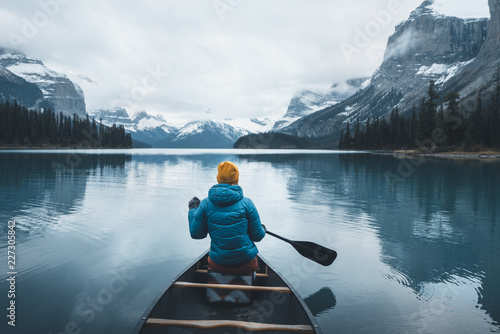 Fototapeta Naklejka Na Ścianę i Meble -  Girl paddling on a blue lake