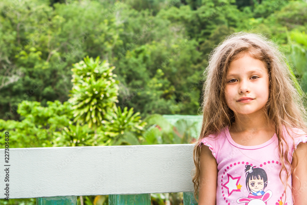 little girl in the garden of flowers little girl in the garden of flowers