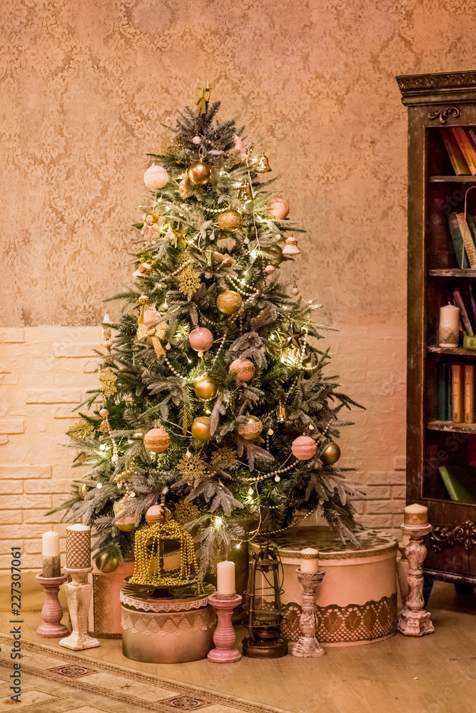 Christmas decor of a retro stylish living room with a vintage furniture, Christmas tree and candles.Merry Christmas and Happy Holidays. A beautiful living room decorated for Christmas.Calm image of Christmas decor of a retro stylish living room with a vintage furniture, Christmas tree and candles.Merry Christmas and Happy Holidays. A beautiful living room decorated for Christmas.Calm image of