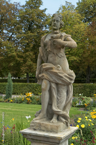 Stone figure of a half-naked woman in the park.
