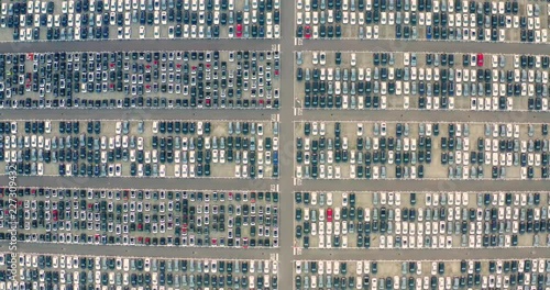 Aerial view of a new car depot, where you can see thousands of cars parked and tidy. Concept of: automotive industry, globalization, world population.