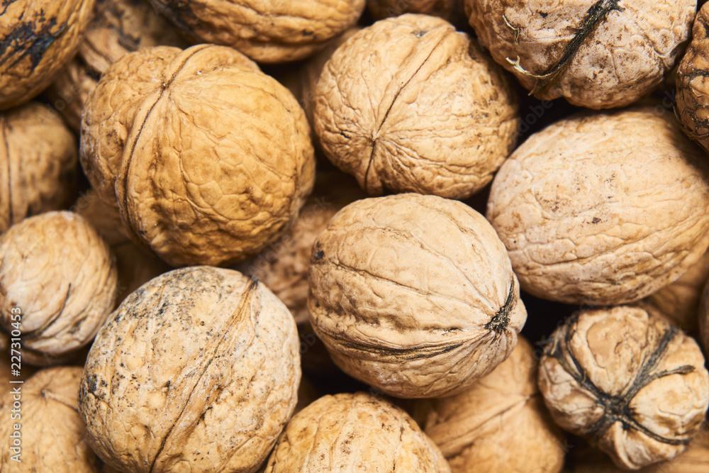 Walnut background, scattered pile of walnuts Walnut background, scattered pile of walnuts