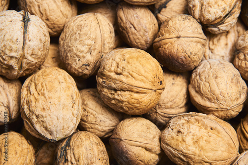 Walnut background, scattered pile of walnuts