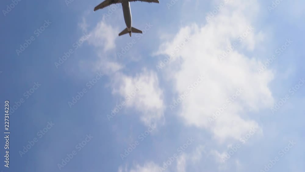 Plane flying over head on blue sky, 4к. Airplane takeoff into the sky. Plane flying over head on blue sky, 4к. Airplane takeoff into the sky.