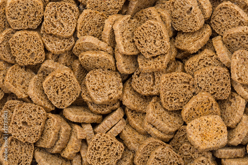 Many small dried rusks  as texture background. photo