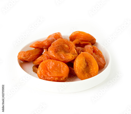 dried apricots in a bowl isolated on white