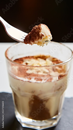 Tiramisu in glass, traditional coffee flavored Italian dessert made of ladyfingers and mascarpone.